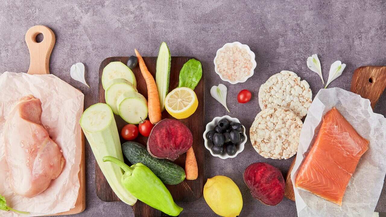 Aesthetics vegetables, chicken fillet, olives, salmon and greens top view. Keto, Paleo, Low carb, FODMAP diet concept